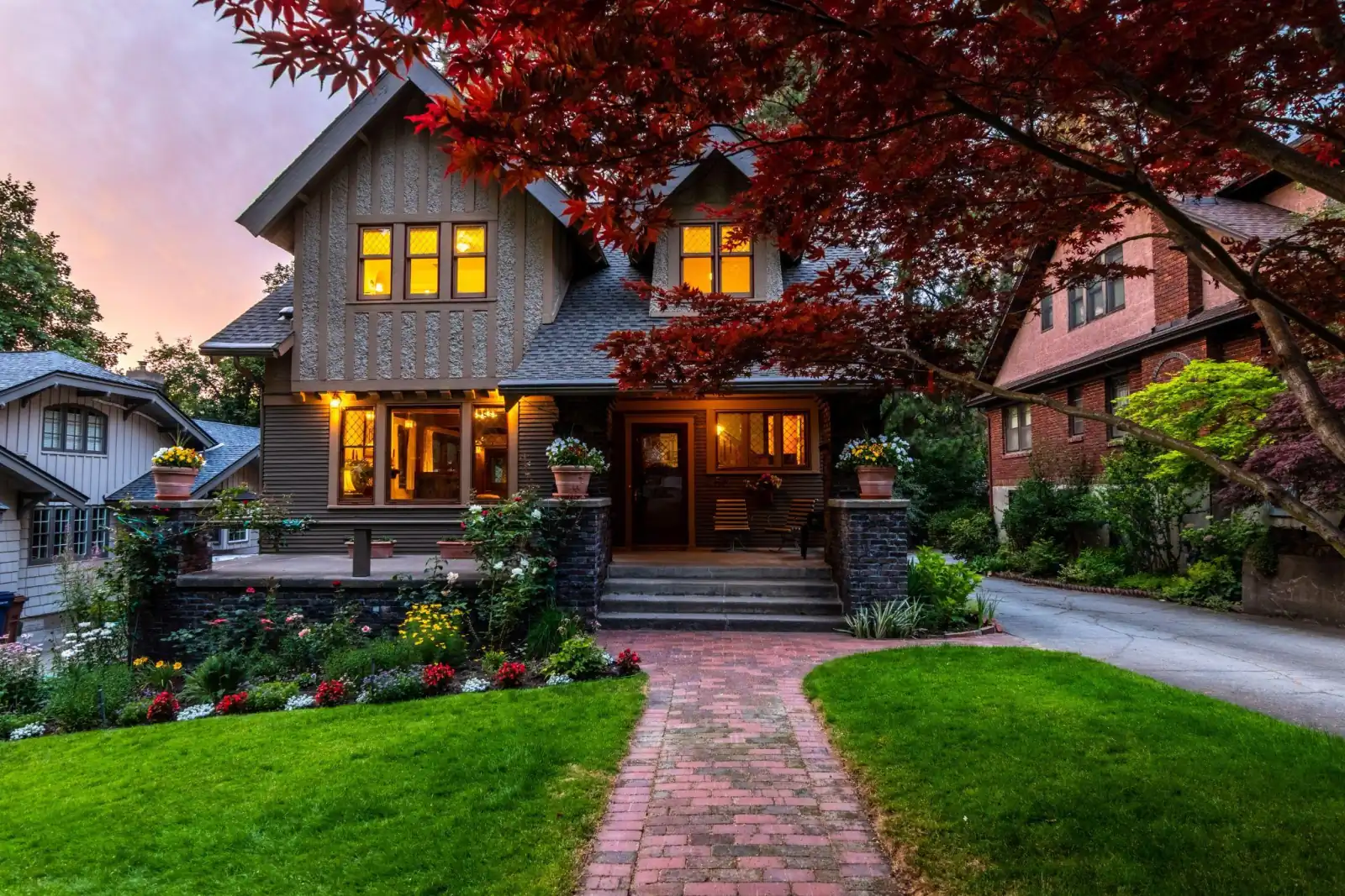 Two-story home with a broad front porch at dusk
