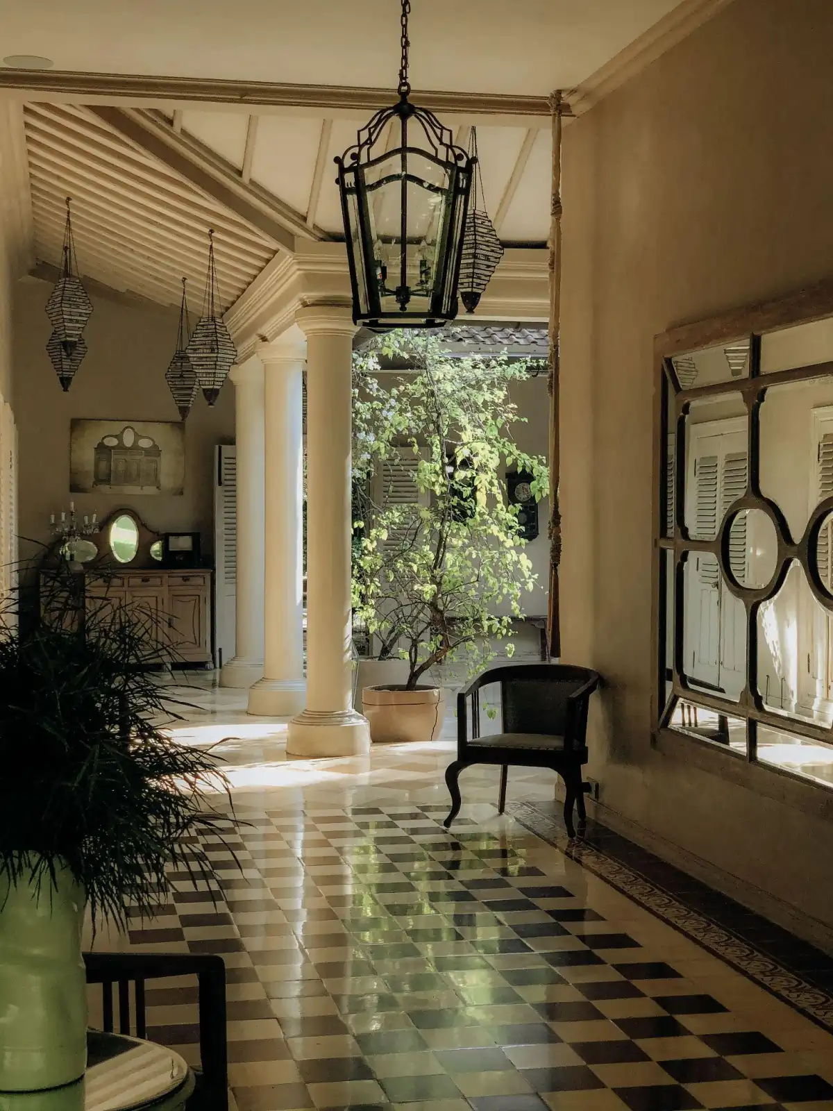 Character-filled hallway with decorative columns, patterned tile, and warm wood details