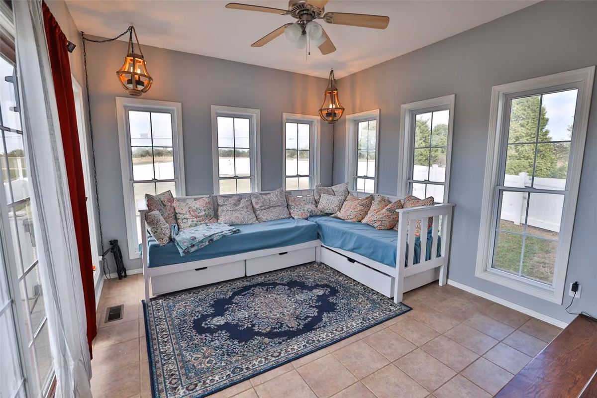 Window-lined room with an L-shaped daybed