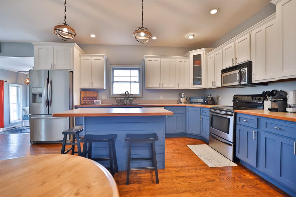 Kitchen with island and two-tone cabinetry at 113 Heritage Trail