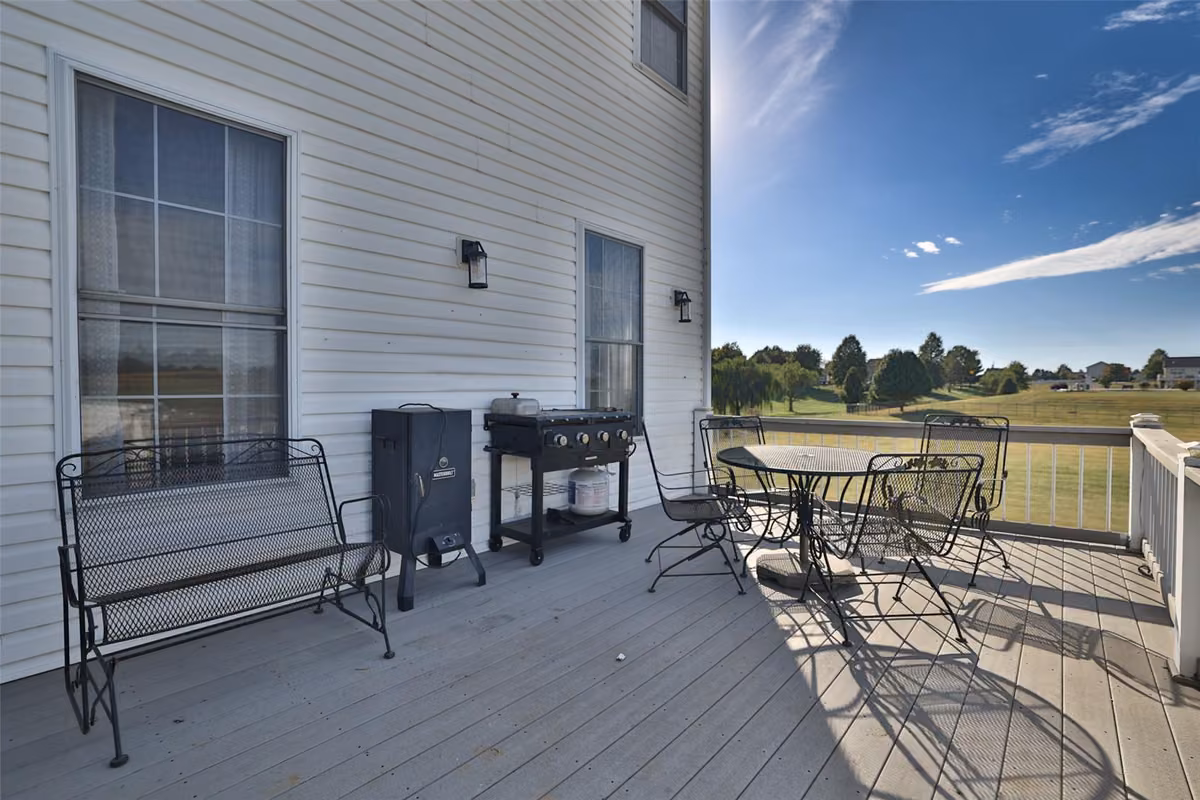 Deck with outdoor seating overlooking the yard