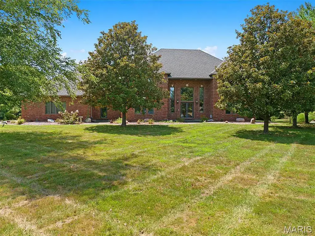 Brick exterior and tree-lined lawn at 517 E Waters Edge Drive in Shiloh